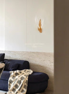 Dandelion glass wall sconce on a clean living room wall