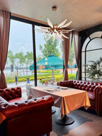 Dandelion linear chandelier in a restaurant window seating area