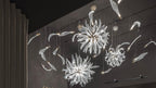 Dandelion glass lighting multi-pendant installation on a dark wall