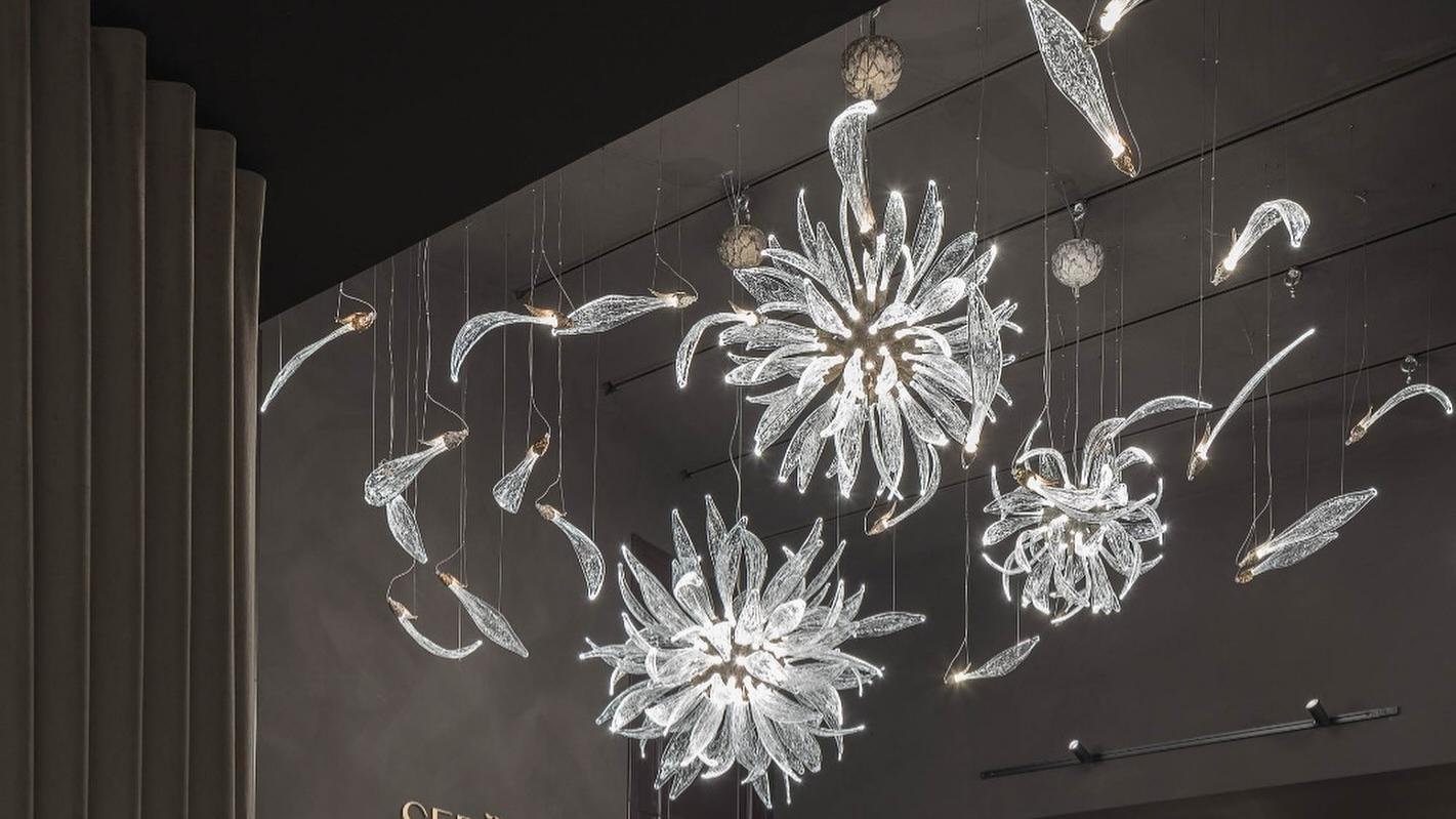 Dandelion glass lighting multi-pendant installation on a dark wall